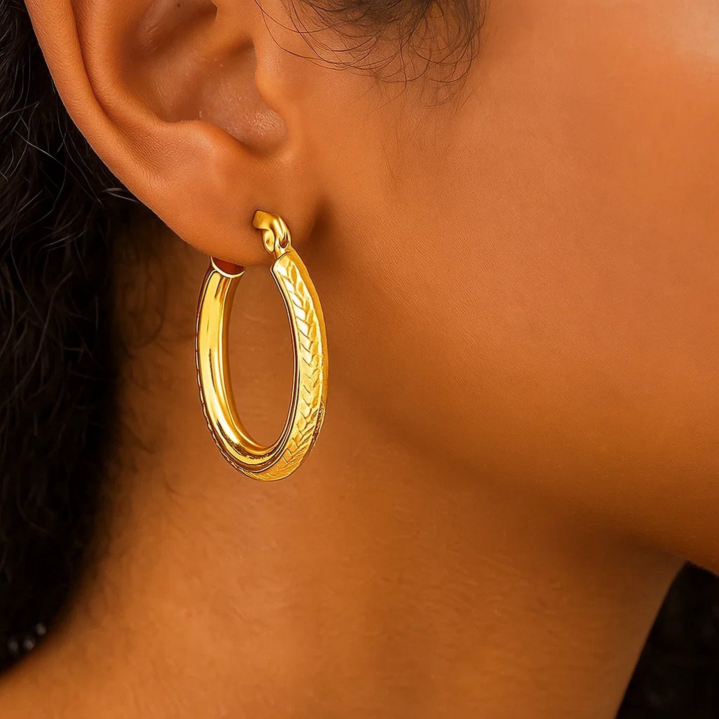 14k Yellow Gold Diamond Cut Textured Oval Hoop Earrings.